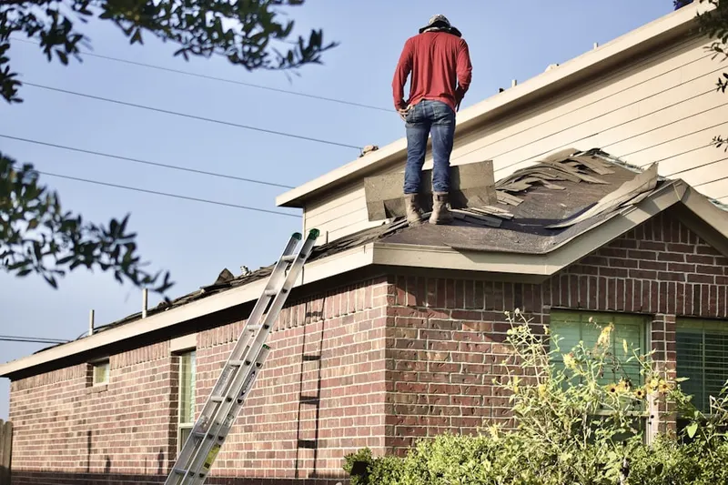 Professional roofer working on a residential roof in California City